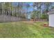 Home boasts a large backyard, privacy fence, mature trees, and a wooden swing set at 311 Old Stone Ct, Moncks Corner, SC 29461