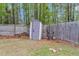 Backyard boasts a storage shed, mature trees, privacy fence, and firewood storage at 311 Old Stone Ct, Moncks Corner, SC 29461