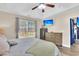 Bright bedroom with a ceiling fan, TV, dresser, and large window for natural light at 311 Old Stone Ct, Moncks Corner, SC 29461