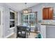 Charming dining area with modern light fixture, seating, and natural light from the window at 311 Old Stone Ct, Moncks Corner, SC 29461