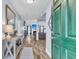 Bright entryway with stylish decor, wood floors, and a view into the living room with a fireplace at 311 Old Stone Ct, Moncks Corner, SC 29461