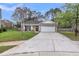 Inviting exterior features a well-maintained front yard, brick accents, and a two-car garage at 311 Old Stone Ct, Moncks Corner, SC 29461