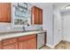 Well-lit kitchen features wood cabinets, stainless steel appliances, and a sink with a window view at 311 Old Stone Ct, Moncks Corner, SC 29461