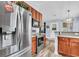 Kitchen featuring stainless steel refrigerator and stove, wood cabinets, and access to dining area at 311 Old Stone Ct, Moncks Corner, SC 29461