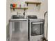 Spacious laundry room with a washer, dryer, and shelving for storage at 311 Old Stone Ct, Moncks Corner, SC 29461