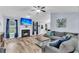 Inviting living room with a fireplace, TV, and a comfortable sectional sofa with modern decor at 311 Old Stone Ct, Moncks Corner, SC 29461