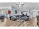 Open-concept living room features a comfortable sectional sofa, wood floors, and seamlessly connects to other spaces at 311 Old Stone Ct, Moncks Corner, SC 29461