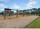 A wooden playground with slides, climbing structures, and swings for Gathering fun at 311 Old Stone Ct, Moncks Corner, SC 29461