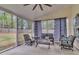 Relaxing screened porch with ceiling fan and comfortable seating area at 311 Old Stone Ct, Moncks Corner, SC 29461