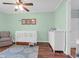 Bright Bedroom with white crib and changing table, complemented by mint-green walls at 341 W Coleman Blvd # F, Mount Pleasant, SC 29464