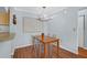 Bright dining area features modern light fixture, wood floors, and seating for four at 341 W Coleman Blvd # F, Mount Pleasant, SC 29464
