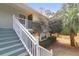 Close up of the exterior stairs leading to the front door, surrounded by mature trees at 341 W Coleman Blvd # F, Mount Pleasant, SC 29464