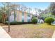 Residential building with a manicured lawn, tall palm trees, and classic architectural details on a sunny day at 341 W Coleman Blvd # F, Mount Pleasant, SC 29464