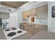 Galley kitchen view features eat-in bar, cabinets, and white appliances at 341 W Coleman Blvd # F, Mount Pleasant, SC 29464