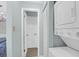 Well-lit laundry area with stacked washer and dryer near an open door at 341 W Coleman Blvd # F, Mount Pleasant, SC 29464