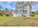 Spacious backyard with a deck, patio, and lush green lawn, perfect for outdoor activities and entertaining at 3805 Adrian Way, Mount Pleasant, SC 29466