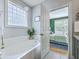 Stylish bathroom featuring a soaking tub and natural light at 3805 Adrian Way, Mount Pleasant, SC 29466