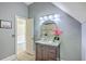 Bathroom with a marble-topped vanity, round mirror, updated lighting, and neutral paint at 3805 Adrian Way, Mount Pleasant, SC 29466