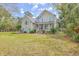 Beautiful two-story home with a well-manicured lawn, accented by light blue shutters and mature trees at 3805 Adrian Way, Mount Pleasant, SC 29466