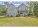 Charming two-story home featuring an inviting front porch, well-manicured lawn, and classic architecture at 3805 Adrian Way, Mount Pleasant, SC 29466