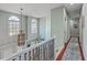Light-filled hallway with hardwood floors, staircase, large windows, and decorative chandelier at 3805 Adrian Way, Mount Pleasant, SC 29466