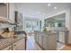 Open-concept kitchen featuring granite countertops, stainless appliances, island, eat-in nook and hardwood flooring at 3805 Adrian Way, Mount Pleasant, SC 29466