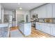 Spacious kitchen features granite countertops, stainless appliances, kitchen island, hardwood flooring and ample storage at 3805 Adrian Way, Mount Pleasant, SC 29466