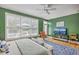 Inviting bedroom offers a calming atmosphere with a ceiling fan and natural light from large windows at 3805 Adrian Way, Mount Pleasant, SC 29466