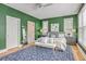 Bright main bedroom boasts vibrant green walls, a plush rug, and a comfortable king bed at 3805 Adrian Way, Mount Pleasant, SC 29466