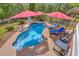 Backyard pool with lounge chairs, patio, and red umbrellas, creating a luxurious outdoor space at 3805 Adrian Way, Mount Pleasant, SC 29466