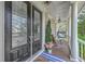 Inviting front porch with double doors, a hanging swing chair, and charming decor creates a welcoming entrance at 3805 Adrian Way, Mount Pleasant, SC 29466