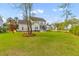 Expansive backyard with lush green grass, mature trees, features an outdoor patio, and a playset at 3873 Newhall St, Mount Pleasant, SC 29466