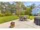 Landscaped backyard with a patio, outdoor furniture, a fire pit, and mature trees at 3873 Newhall St, Mount Pleasant, SC 29466