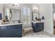 Bright bathroom showcasing double sinks, white countertops, patterned tile floor, and woven bench seat at 3873 Newhall St, Mount Pleasant, SC 29466