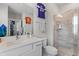 Bright bathroom featuring a glass shower, white vanity, and sports jersey wall decor at 3873 Newhall St, Mount Pleasant, SC 29466