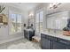 Bright bathroom featuring double sinks, decorative tile floor, white countertops, and plantation shutters at 3873 Newhall St, Mount Pleasant, SC 29466