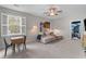 Relaxing bonus room with comfortable sofa, ceiling fan, side table, and bright natural light at 3873 Newhall St, Mount Pleasant, SC 29466