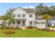 Charming two-story white home featuring a welcoming front porch and a well-manicured lawn at 3873 Newhall St, Mount Pleasant, SC 29466