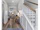 Elegant foyer with wainscoting, hardwood floors, staircase, and seamless flow to the living area at 3873 Newhall St, Mount Pleasant, SC 29466