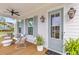 Inviting front porch with seating, stylish decor, and a ceiling fan, perfect for relaxation at 3873 Newhall St, Mount Pleasant, SC 29466