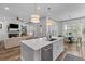 Open kitchen with an island, stainless steel appliances, and a view into the adjacent living room at 3873 Newhall St, Mount Pleasant, SC 29466