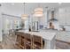 Bright, open kitchen with an island, stainless steel appliances, and wooden chairs at 3873 Newhall St, Mount Pleasant, SC 29466