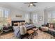 Serene main bedroom with large windows, neutral tones, and comfortable seating area at 3873 Newhall St, Mount Pleasant, SC 29466