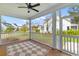 Screened-in porch with a geometric rug, ceiling fan, and views of the front yard and neighborhood at 3873 Newhall St, Mount Pleasant, SC 29466