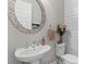 Stylish powder room featuring a unique mirror, modern fixtures, and elegant decorative accents at 3873 Newhall St, Mount Pleasant, SC 29466