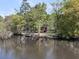 Aerial view showcases a charming home nestled on the riverbank at 394 Shoofly Rd, Ridgeville, SC 29472