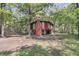 Unique raised home featuring a chimney, arched windows and surrounded by beautiful mature trees at 394 Shoofly Rd, Ridgeville, SC 29472