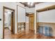 Hallway with wood floors and trim features multiple doorways to other rooms in the house at 394 Shoofly Rd, Ridgeville, SC 29472