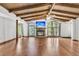 Open-concept living room with high ceilings, wood floors, arched windows, and a fireplace and TV at 394 Shoofly Rd, Ridgeville, SC 29472