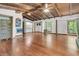 Open concept living room featuring hardwood floors and a beamed ceiling at 394 Shoofly Rd, Ridgeville, SC 29472